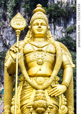 Murugan the Hindu God of war and victory. This statue of Murugan can be found at the Batu caves in Kuala Lumpur. Square on view showing the intricate detail. 115021658