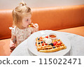 Classic Viennese waffles with ice cream, berries and Maple syrup. Breakfast in cafe. Table in the restaurant. 115022471