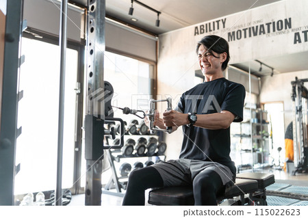 Young Asian man doing muscle training and working out at the gym/sports gym (back training/rowing) Young Asian man doing muscle training and working out at the gym/sports gym (back training/rowing) 115022623