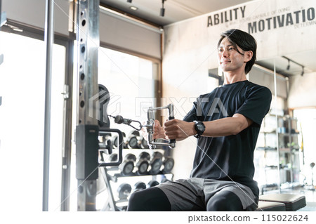 Young Asian man doing muscle training and working out at the gym/sports gym (back training/rowing) Young Asian man doing muscle training and working out at the gym/sports gym (back training/rowing) 115022624