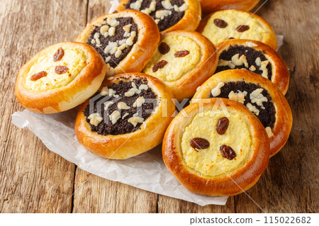Traditional sweet yeast dough kolache kolace with delicious poppy seeds filling and streusel topping and cream cheese filling closeup. Horizontal 115022682