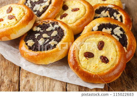 Sweet yeast buns Czech kolache made with cottage cheese or poppy seeds closeup. Horizontal 115022683