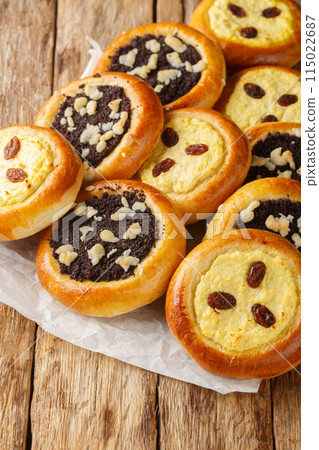 Czech and Slovak Kolach or kolace type of sweet yeast pastry filling with cottage cheese, poppy seeds closeup. Vertical 115022687