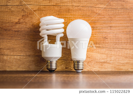 Energy saving light bulb . Fluorescent and led Lightbulb on wooden table. Energy saving light bulb . Fluorescent and led Lightbulb on wooden table. 115022829