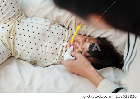 mother brushing her daughters teeth. crying baby with tooth brush mother brushing her daughters teeth. crying baby with tooth brush 115023826
