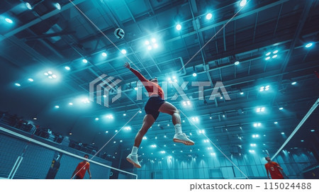 Volleyball match in a professional sports indoor court. A player in mid air about to strike the ball Volleyball match in a professional sports indoor court. A player in mid air about to strike the ball 115024488