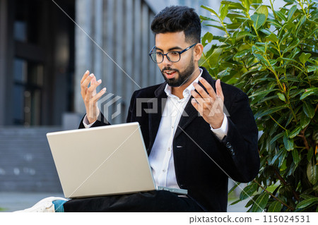 Businessman working on laptop reading good news, rejoicing success, celebrate online win victory Businessman working on laptop reading good news, rejoicing success, celebrate online win victory 115024531