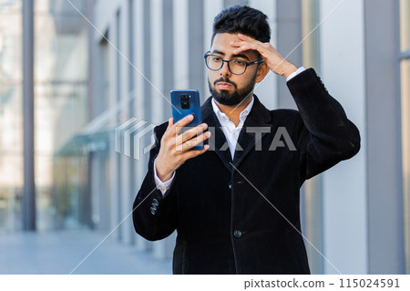 Surprised business man use smartphone loses, bad news, fortune loss, fail outdoors in city street 115024591