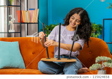 Woman finishing assembling furniture at home in new apartment successful table collect repair fixing 115024658