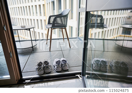 Two pairs of sneakers shoes drying on balcony. Matching white sneakers for man and woman. Two pairs of sneakers shoes drying on balcony. Matching white sneakers for man and woman. 115024875
