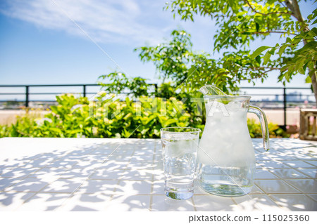 Stay hydrated on the terrace. Drink cold mineral water at a table in the shade. Stay hydrated on the terrace. Drink cold mineral water at a table in the shade. 115025360
