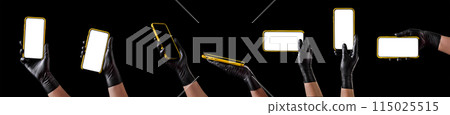 Hand in black glove holding mobile phone with blank screen isolated on black 115025515