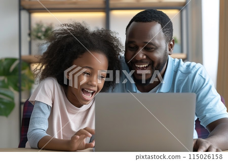 Happy father and child at laptop. Daddy and daughter having fun. Happy father and child at laptop. Daddy and daughter having fun. 115026158