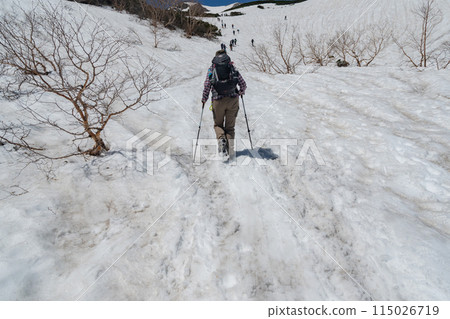 Climbing a snowy mountain when snow still remains Climbing a snowy mountain when snow still remains 115026719