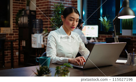 Zoom in on company accountant typing down financial notes on laptop and analyzing sales report to plan business development. Office employee using computer to do project research 115027196