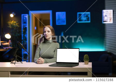 Gen Z teenager does influencer marketing by presenting followers mockup laptop sponsored by company. Media star fulfilling brand advertising contract by showcasing isolated screen notebook 115027288
