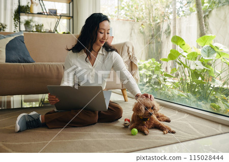 Young Woman Petting Dog 115028444