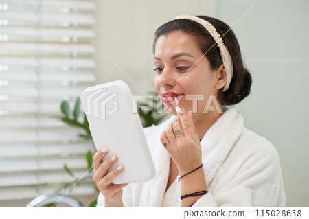 Woman Applying Red Lipstick 115028658