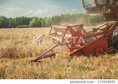 A combine harvester mowing low, poor grain yields 115028695
