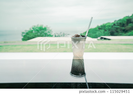 A cool drink at a cafe with a view of the sea 115029451