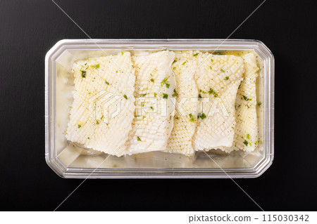 Seasoned squid steak (with green onion and salt sauce) before cooking Seasoned squid steak (with green onion and salt sauce) before cooking 115030342