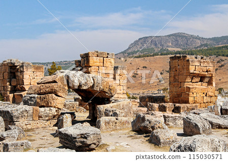 Marble stone columns and arches of ancient ruins of Hierapolis, Pamukkale, Turkey. UNESCO World Heritage Site in Turkey. Destroyed ancient city in Europe. Popular tourist destination in Turkey 115030571