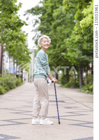 Smiling senior woman with a cane Smiling senior woman with a cane 115031961