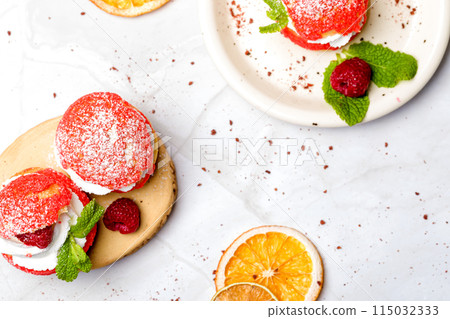 Shu cake. Custard dessert with creamy white cream, decorated with raspberries 115032333