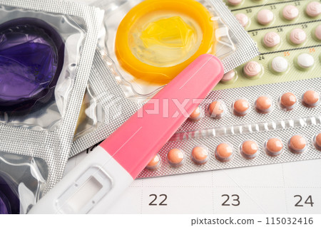 Pregnancy test and birth control pills on calendar, contraception health and medicine. Pregnancy test and birth control pills on calendar, contraception health and medicine. 115032416