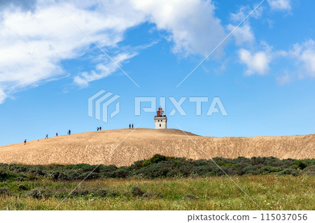 Rubjerg Knude Lighthouse on the coast of the North Sea in the Jutland in northern Denmark. Rubjerg Knude Lighthouse on the coast of the North Sea in the Jutland in northern Denmark. 115037056