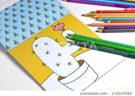 Colored pencils for drawing various colors and coloring book for children.  115037088