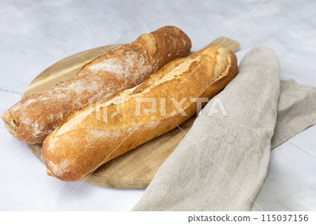 Freshly baked bread on a cutting board. Freshly baked bread on a cutting board. 115037156