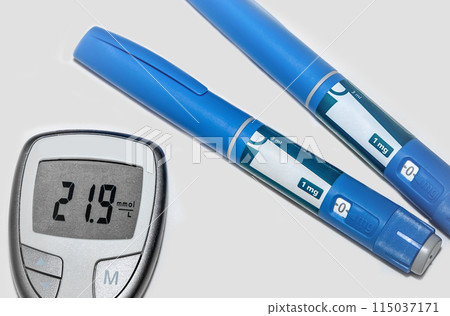 Blood sugar meter with test strips indicates high blood sugar levels and injection pen for diabetes.  115037171