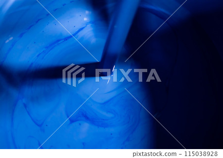 Stirring blue paint 115038928
