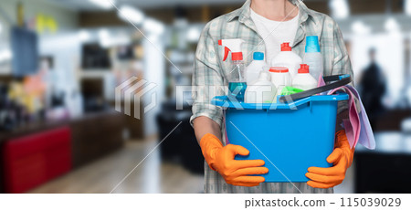 Cleaning woman with a bucket of cleaning products . Cleaning woman with a bucket of cleaning products . 115039029