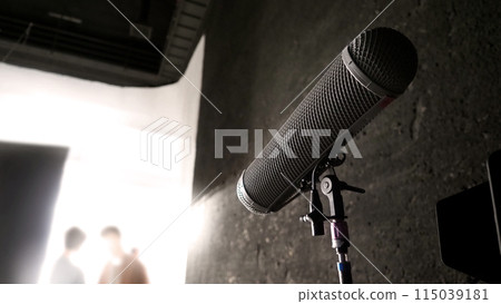 Boom Microphone In Set. Boom Microphone on stand in Video Production which recording audio of talent model and ambient sound in studio. Pro mic for audio capture in film industry and audio recording. Boom Microphone In Set. Boom Microphone on stand in Video Production which recording audio of talent model and ambient sound in studio. Pro mic for audio capture in film industry and audio recording. 115039181