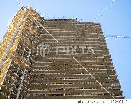 Construction of a modern high house. Building frame. Gray concrete structure. Unfinished house. 115040141