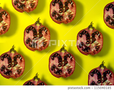 Background of pomegranate halves.Juicy fruit on a yellow background. Seeds inside the fruit. Raw food diet. Sliced pomegranate Background of pomegranate halves.Juicy fruit on a yellow background. Seeds inside the fruit. Raw food diet. Sliced pomegranate 115040185