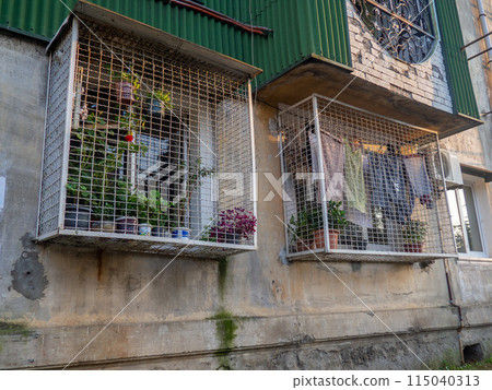 Unusual grilles for windows. Greenhouse on the window. window in a cage. 115040313