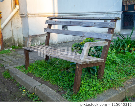 Benches in the autumn yard. Fallen leaves on the pavement. autumn in the south. empty benches. 115040315
