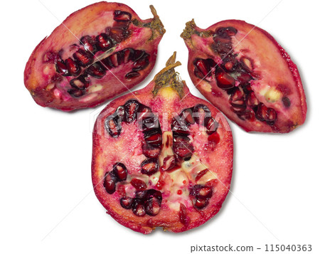 Sliced pomegranate on a white background. Juicy fruit with seeds. Pieces of red fruit. Juicy pulp. Pomegranate isolate. Juice ingredient. 115040363