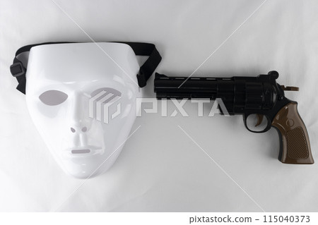 White mask, toy gun and handcuffs White mask, toy gun and handcuffs 115040373