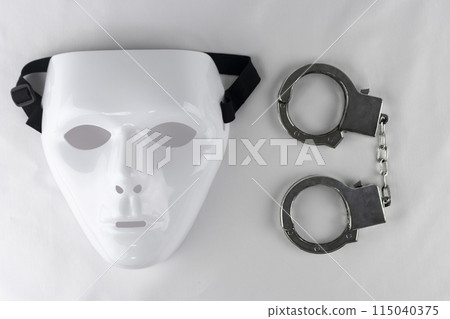 White mask and toy handcuffs White mask and toy handcuffs 115040375