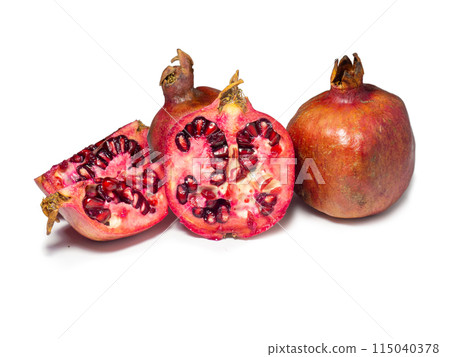 Sliced pomegranate on a white background. Juicy fruit with seeds. Pieces of red fruit. Juicy pulp. Pomegranate isolate. Juice ingredient. 115040378