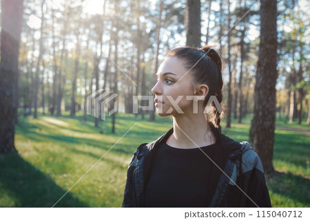 Serene woman enjoying sunset in forest 115040712