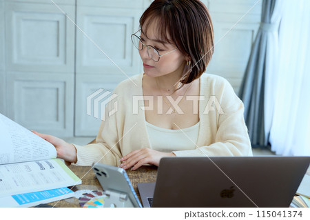 Female designer working at a computer at home 115041374
