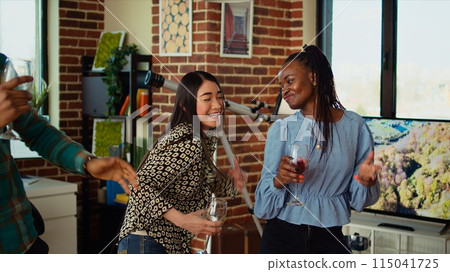BIPOC group of friends dancing at apartment party, having fun together, shaking their shoulders on rhythm. Multiethnic people doing energetic dance moves, doing funny choreography in living room BIPOC group of friends dancing at apartment party, having fun together, shaking their shoulders on rhythm. Multiethnic people doing energetic dance moves, doing funny choreography in living room 115041725