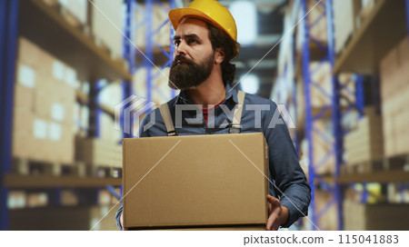 Packaging operator carrying stock boxes in warehouse, trying to organize merchandise on pallets. Employee maintaining inventory in industrial storage room, load and unload production. Packaging operator carrying stock boxes in warehouse, trying to organize merchandise on pallets. Employee maintaining inventory in industrial storage room, load and unload production. 115041883