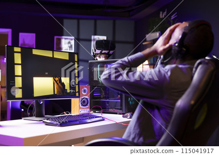 Gamer upset after losing while playing FPS cyberspace videogames on PC monitor. Man putting face in hands in frustration after being defeated playing online games on computer at desk Gamer upset after losing while playing FPS cyberspace videogames on PC monitor. Man putting face in hands in frustration after being defeated playing online games on computer at desk 115041917
