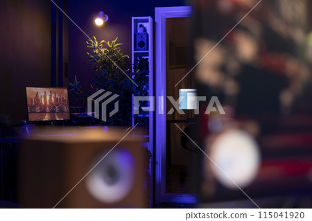 3D animation left open on PC screen in background in empty neon illuminated apartment living room. 3D rendering on computer desktop display in RGB lit home late at night with no people in 3D animation left open on PC screen in background in empty neon illuminated apartment living room. 3D rendering on computer desktop display in RGB lit home late at night with no people in 115041920